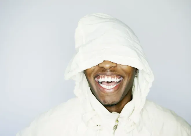 person with sweatshirt hood over face