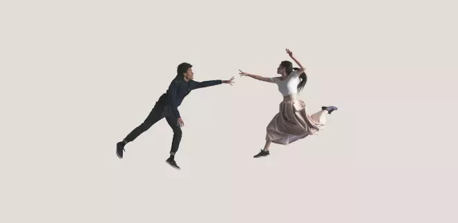 two people extending arms to each other