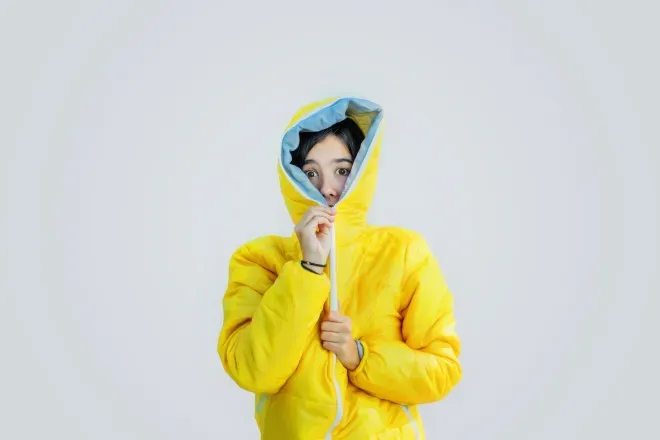 person zipping up jacket