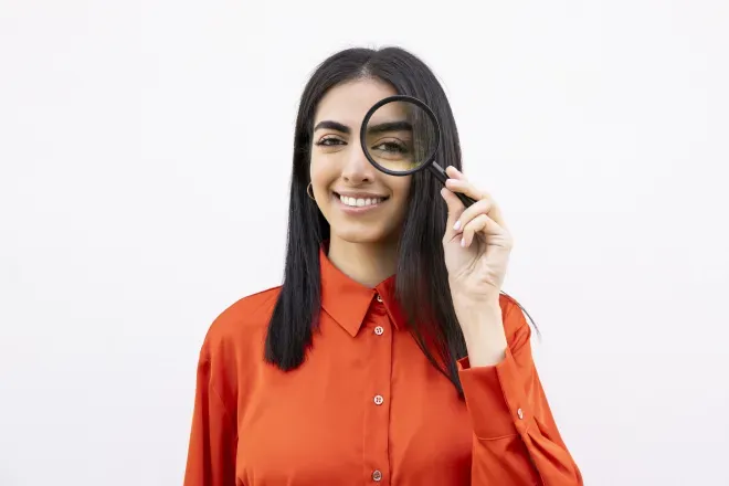 Woman holding magnifying glass