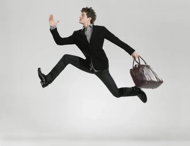 man jumping in the air holding a briefcase man jumping in the air holding a briefcase