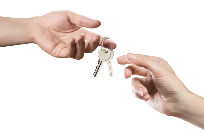 two hands reaching for a pair of metal keys beind handed to the other