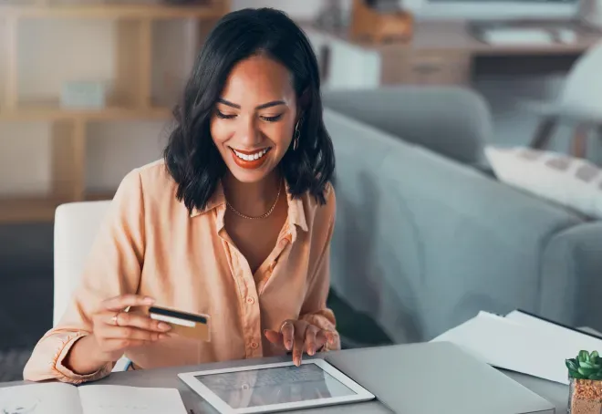 Young Woman in creme blouse smiling and holding a card. Young Woman in creme blouse smiling and holding a card.