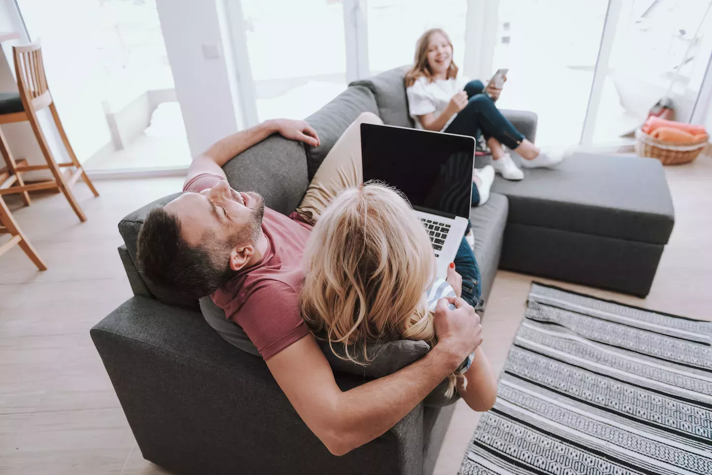 Family sitting on the couch laughing