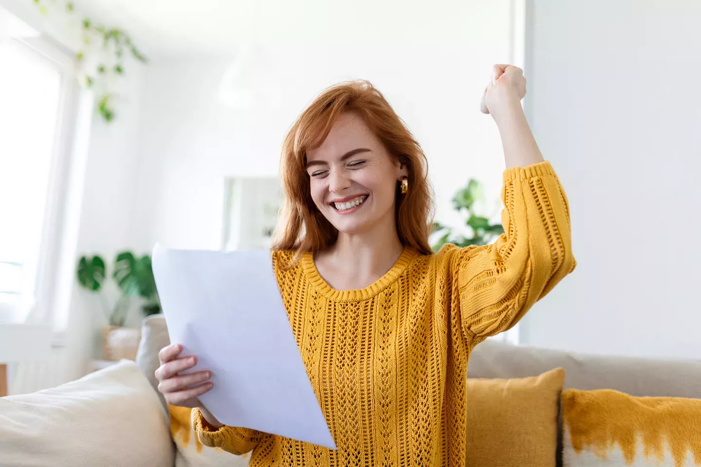 Woman smiling holding papers Woman smiling holding papers