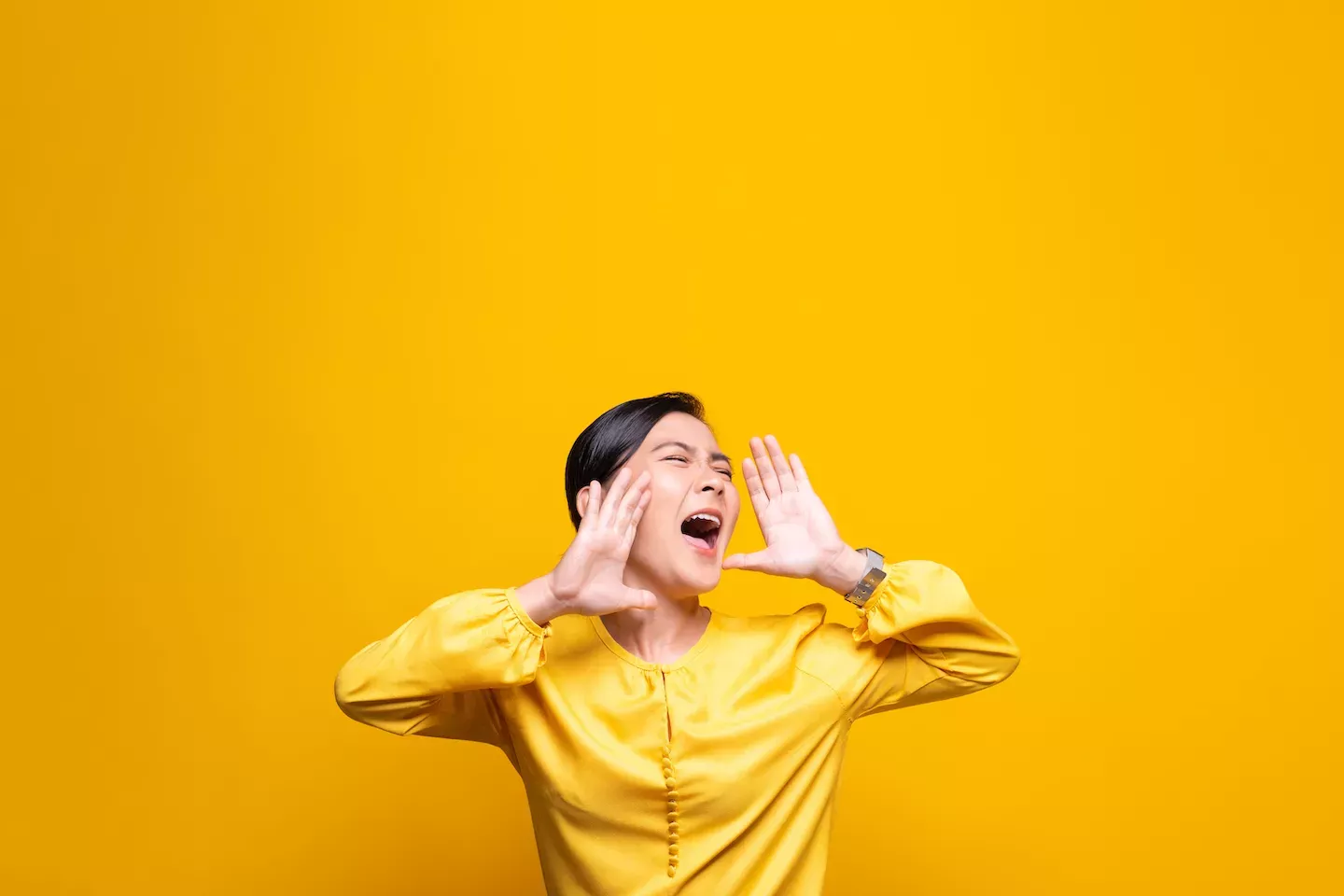 Woman shouting in a yellow shirt