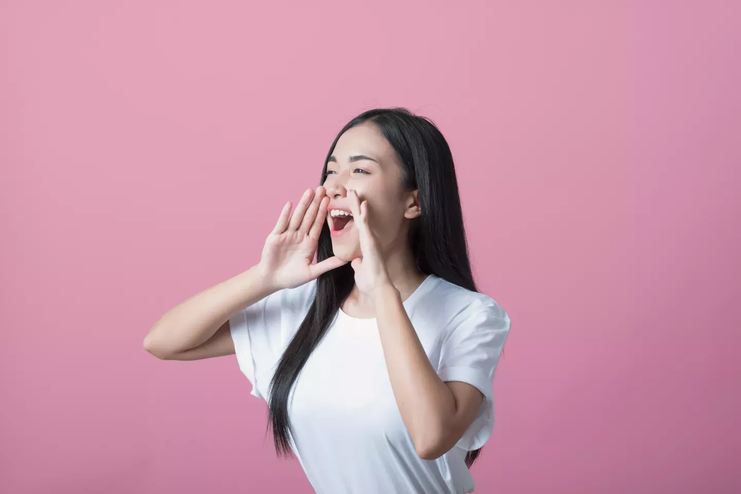 woman holding hands to mouth to shout