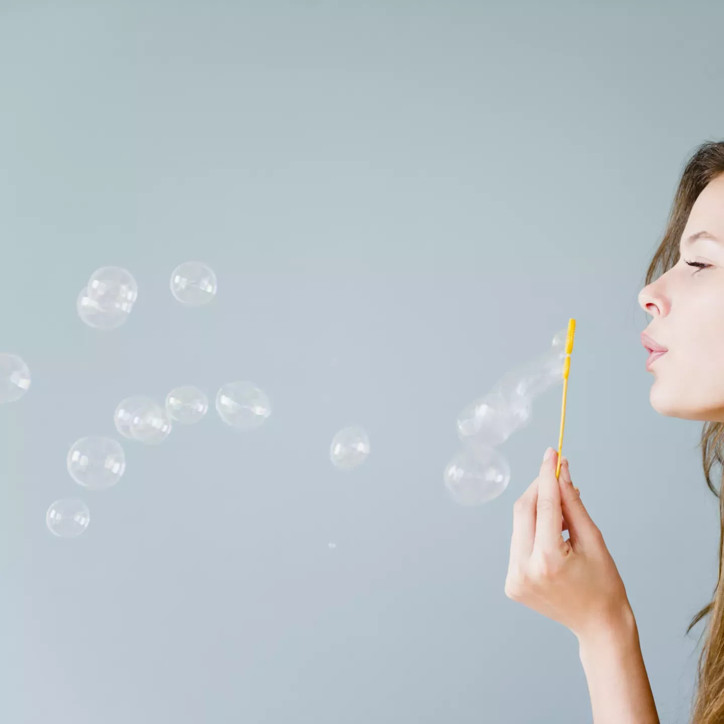 Woman blowing bubbles
