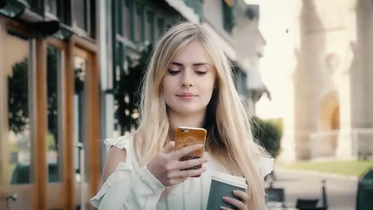person holding and looking at phone
