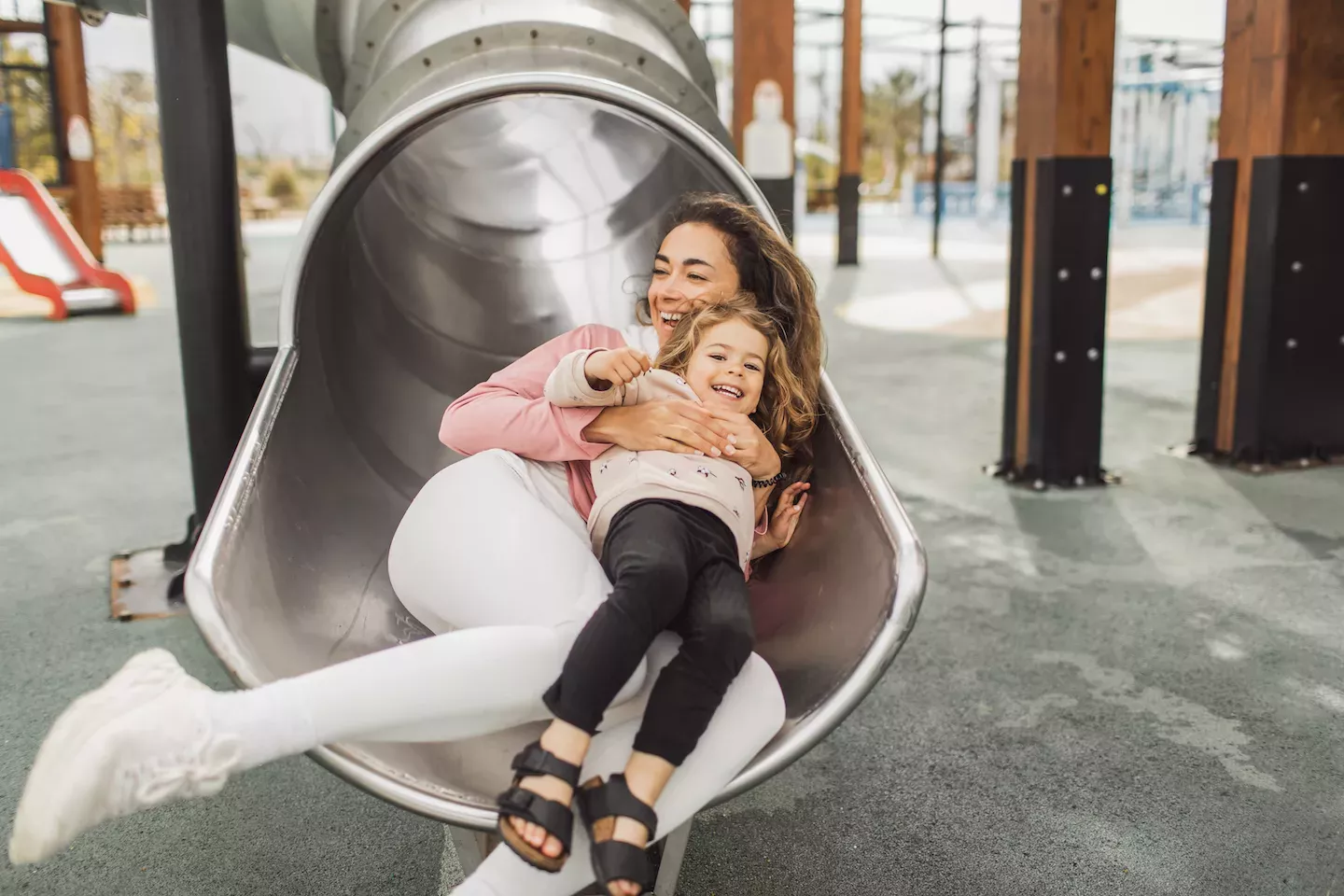 Mom and daughter going down a slide