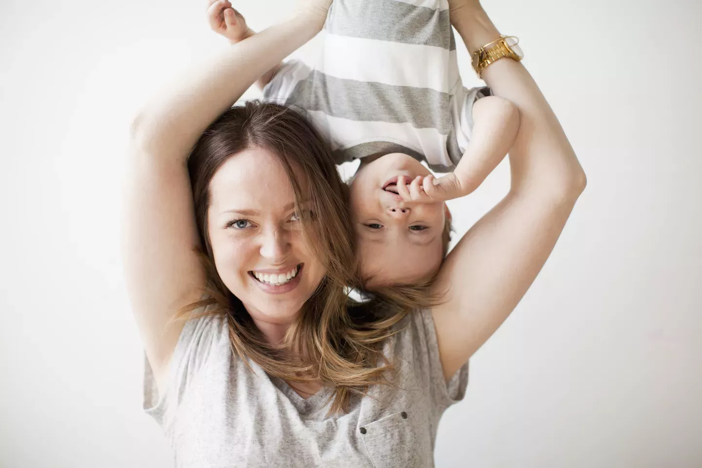 Mom holder her kid upside down