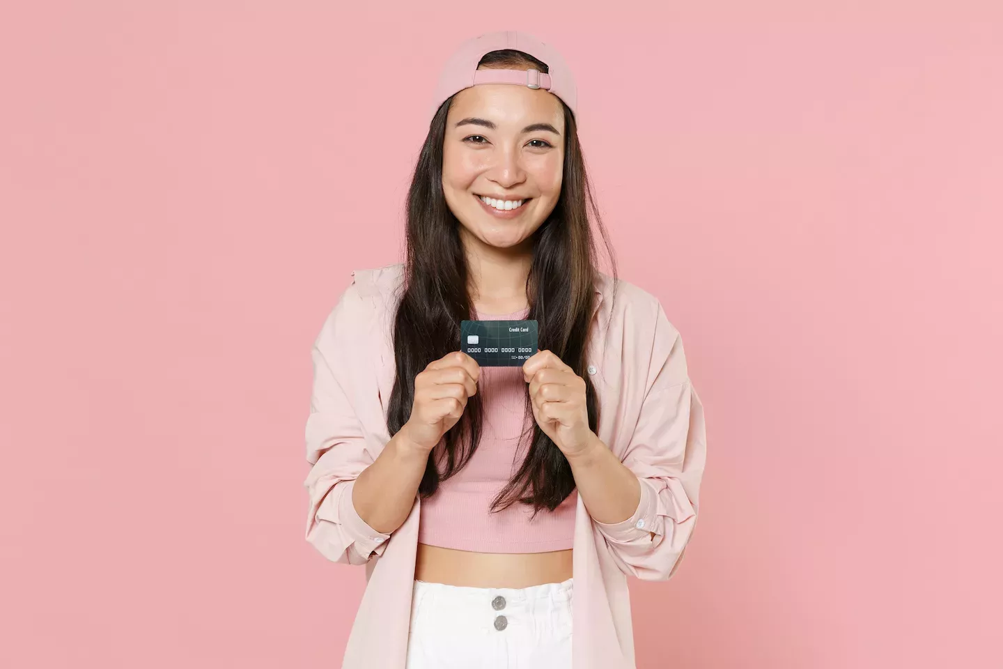 Woman holding a credit card Woman holding a credit card