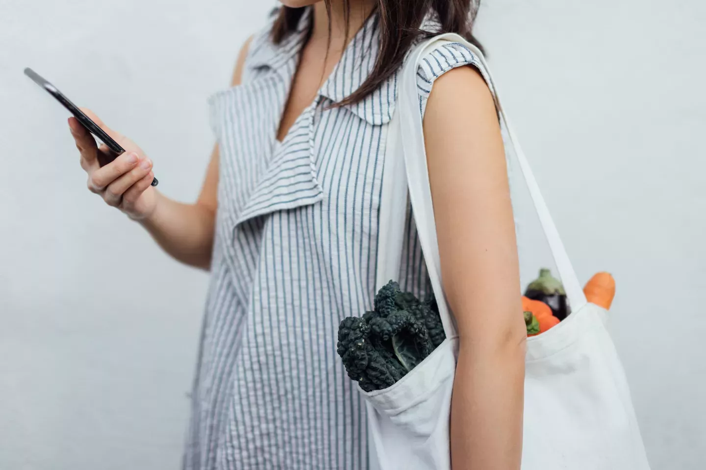 Woman on the phone holding groceries Woman on the phone holding groceries