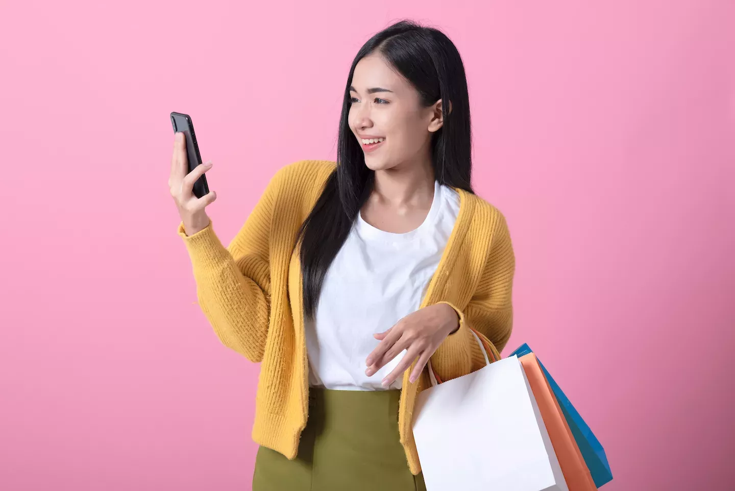 Woman shopping and looking at phone Woman shopping and looking at phone