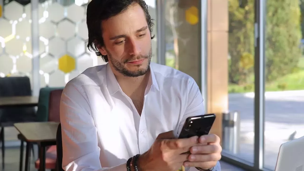 man staring at phone