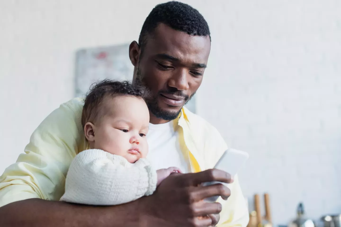 Man and baby looking at phone