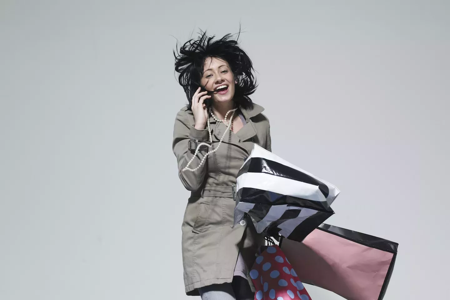 person talking on phone holding shopping bags person talking on phone holding shopping bags