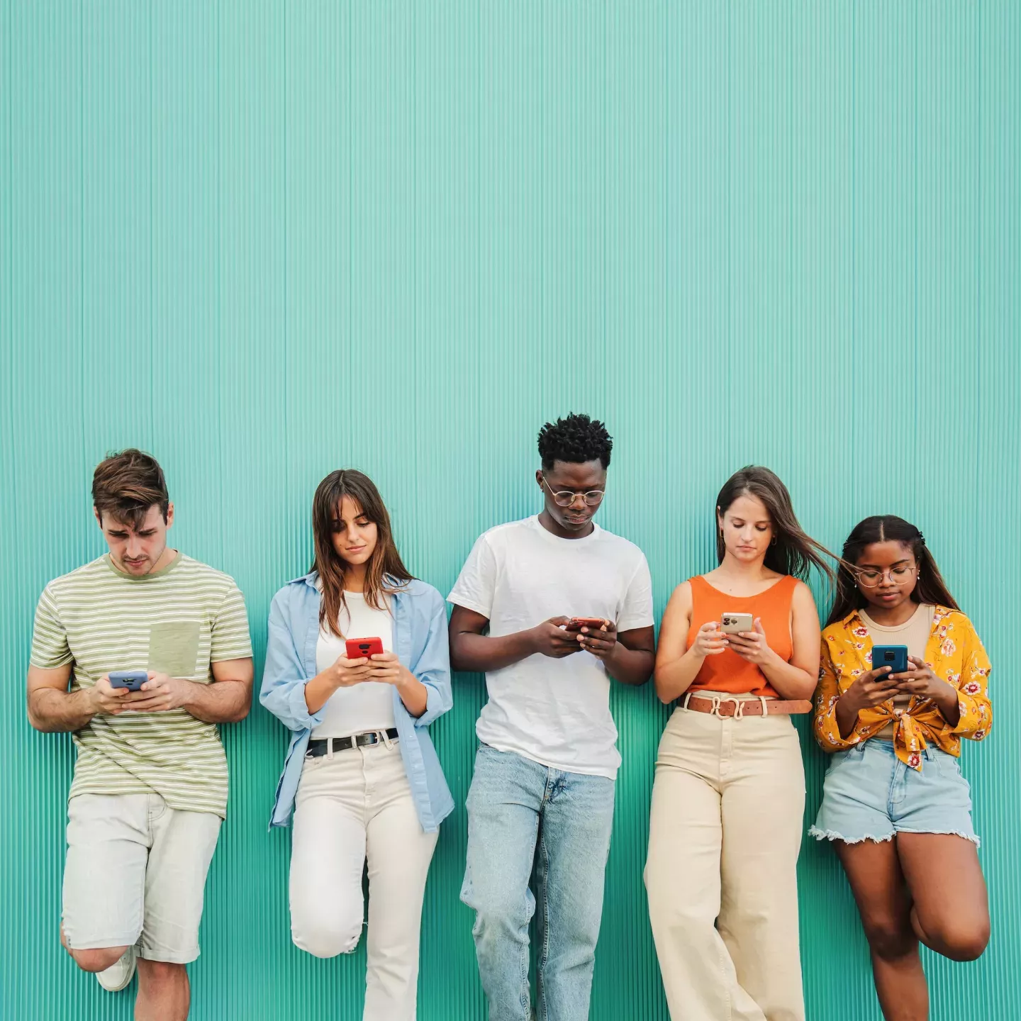 Group of young adults with phones Group of young adults with phones