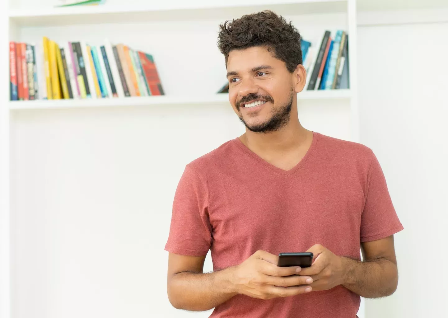 person smiling holding cellphone person smiling holding cellphone
