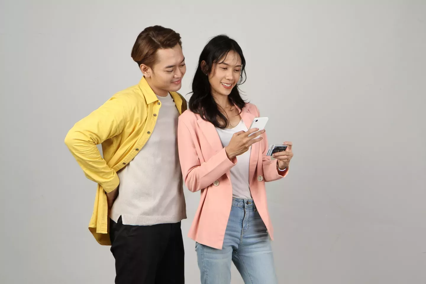 Man and woman with card and phone