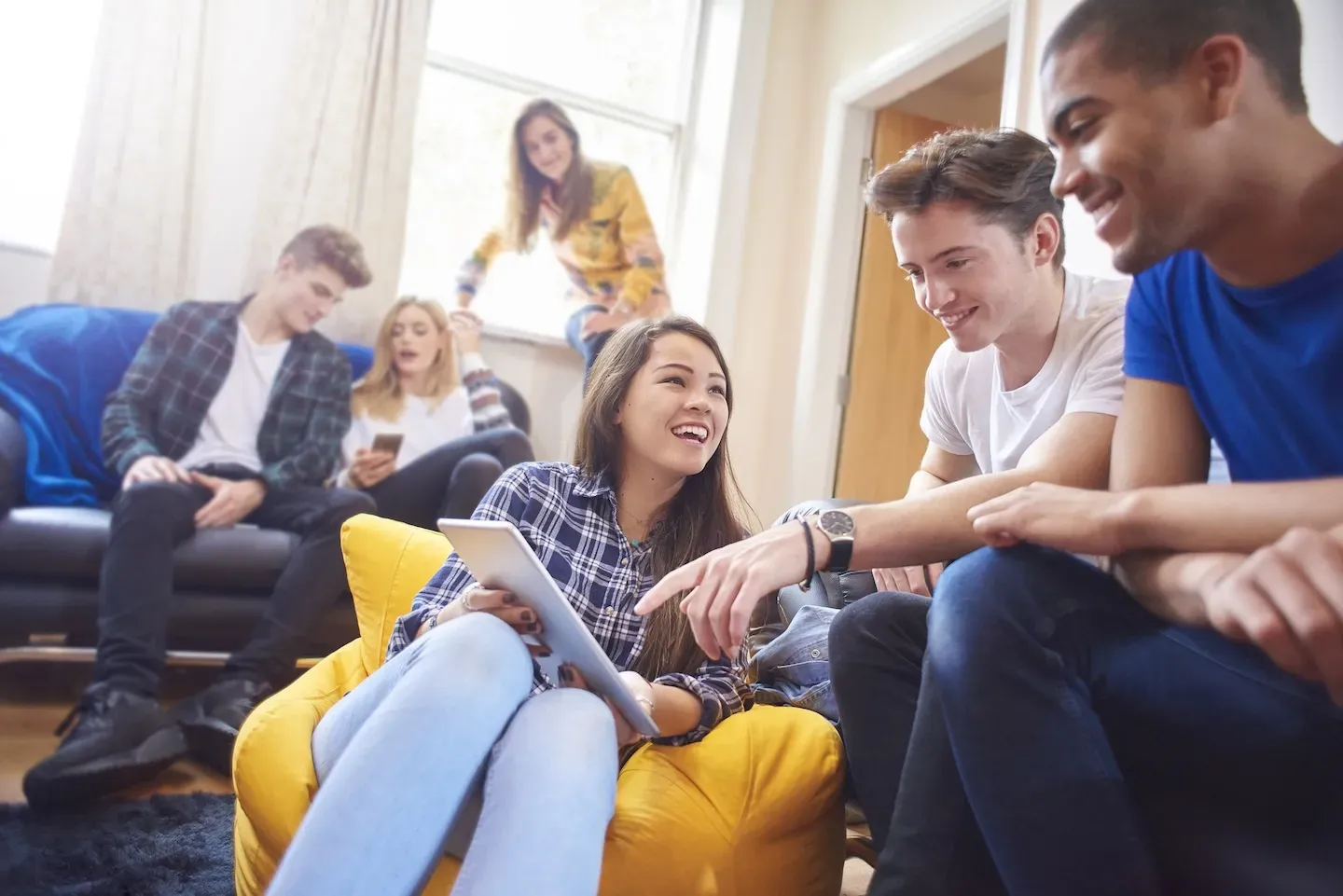 Group of students smiling and working on a project together
