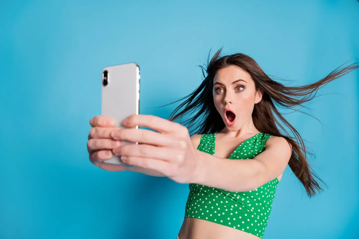 Surprised young woman with phone