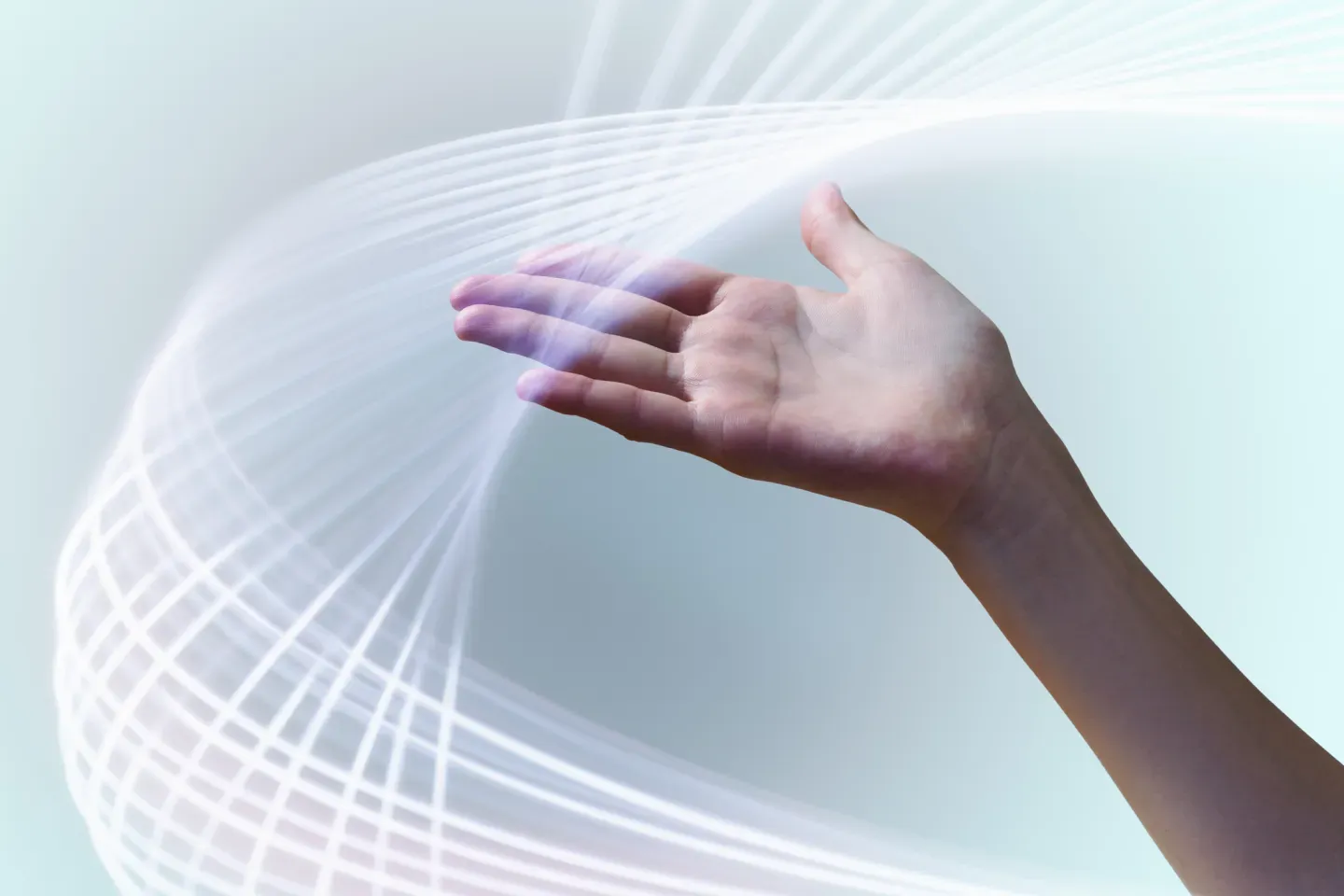 An outstretched hand with glowing white swirling light waves on a soft blue background.