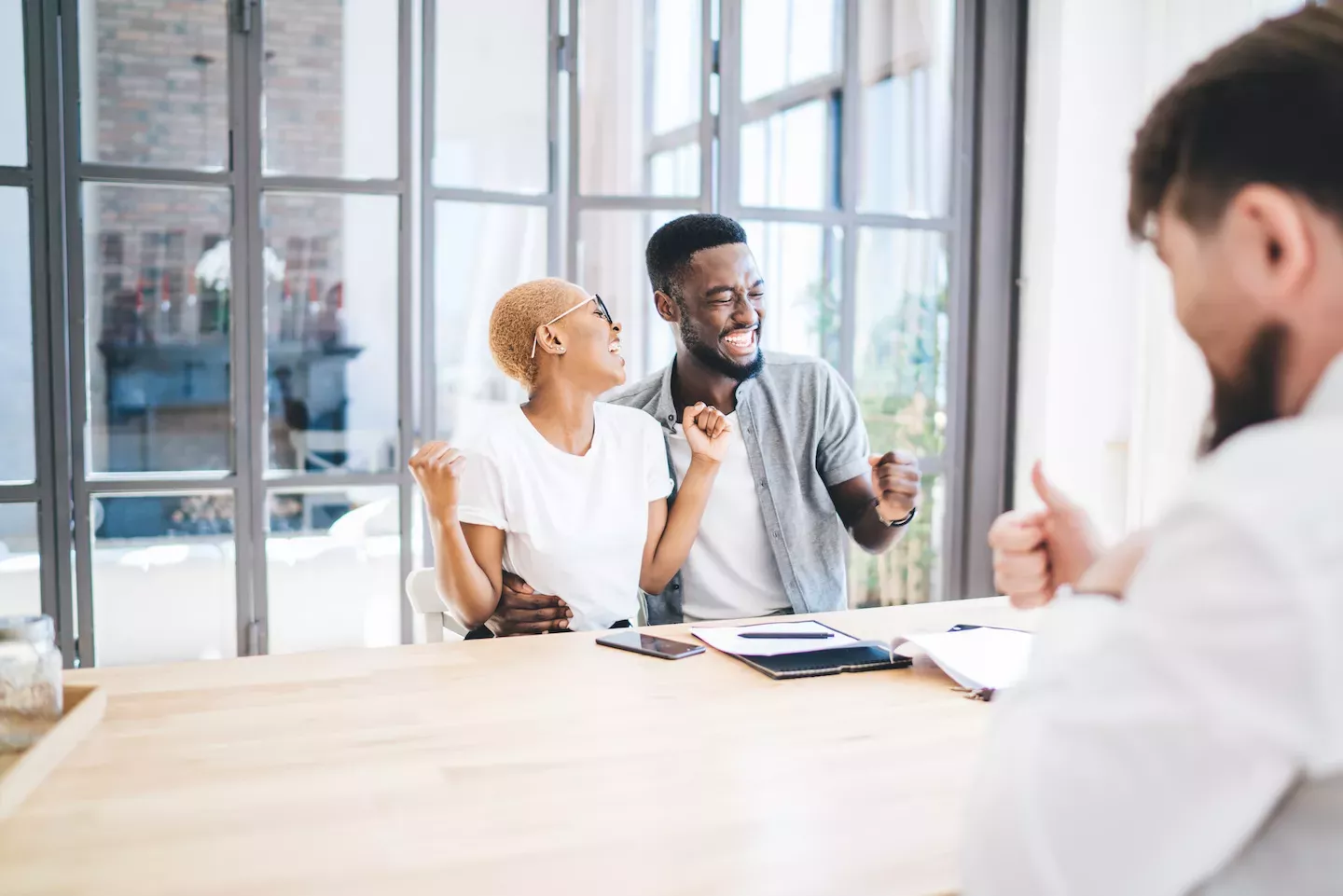 Happy couple getting approved for a loan Happy couple getting approved for a loan