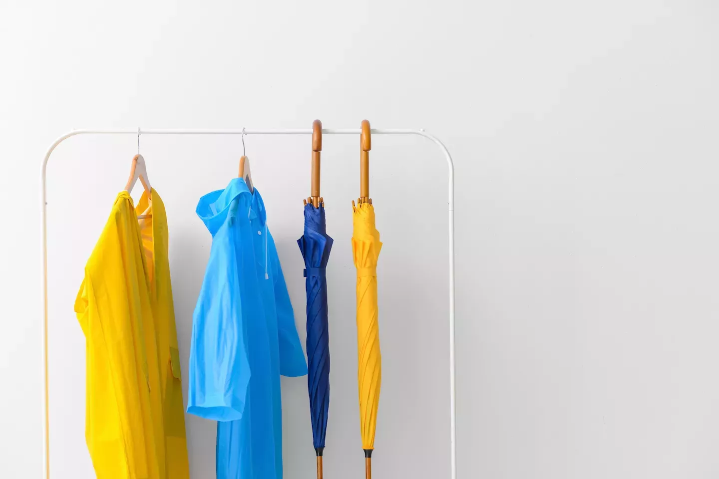Rack with raincoats and umbrellas