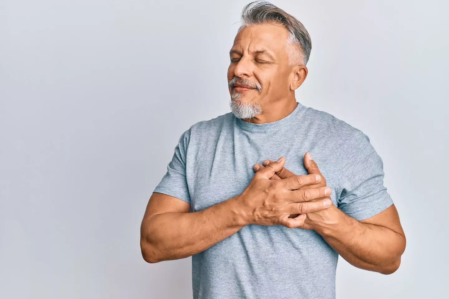 Man holding his hands over his heart