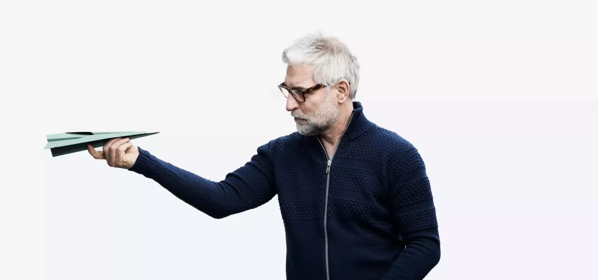 Man looking at a paper airplane