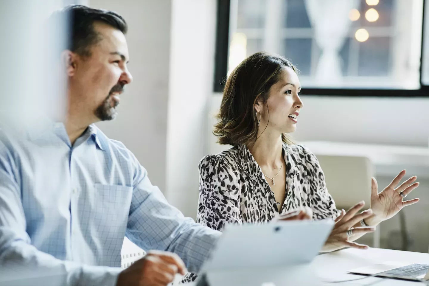 Colleagues talking in an office setting