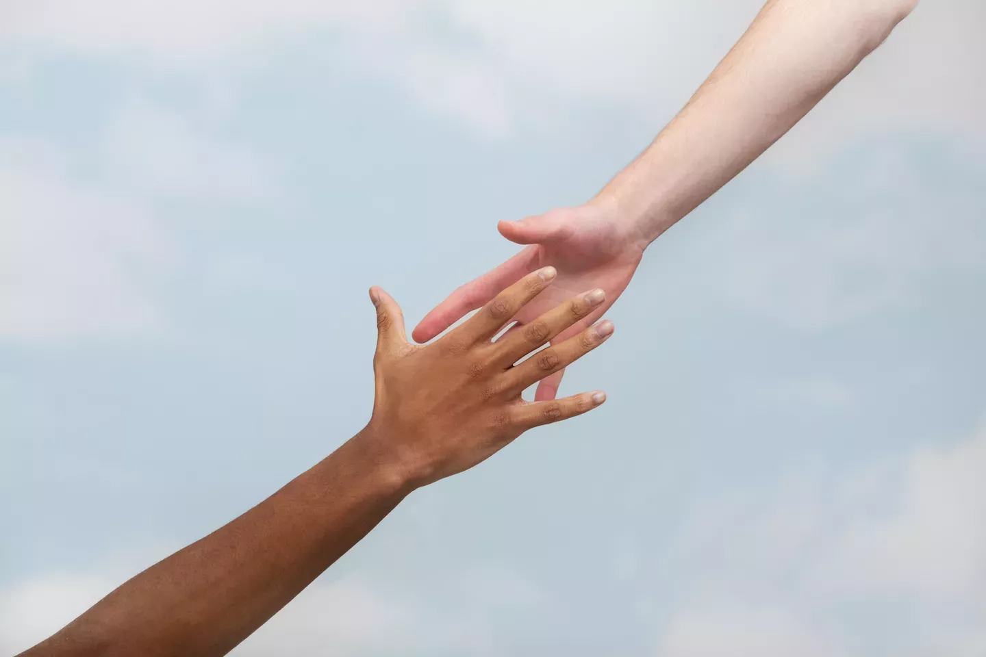 People reaching out to grab hands