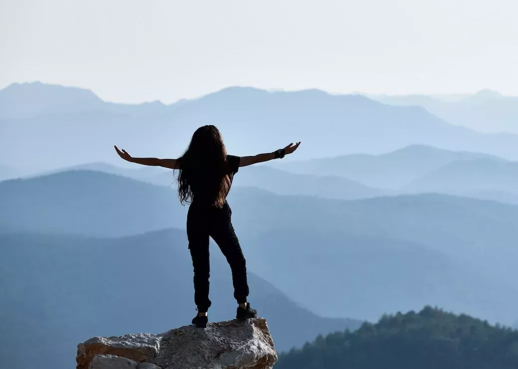 woman standing on cliff woman standing on cliff