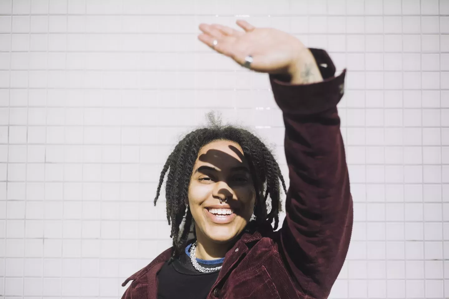 person blocking sunlight with hand