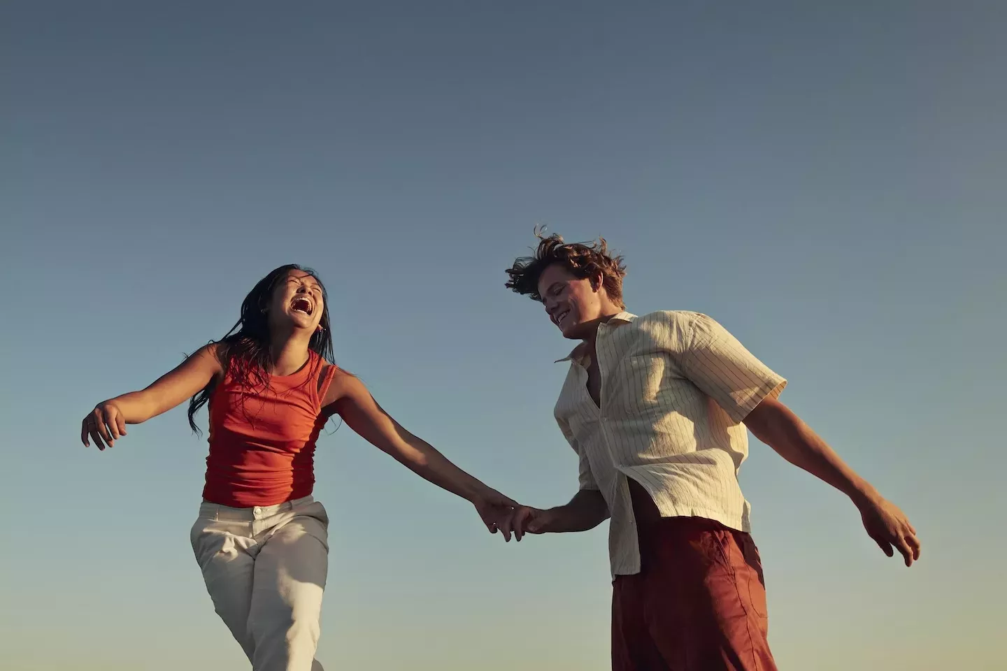 two happy people holding hands 