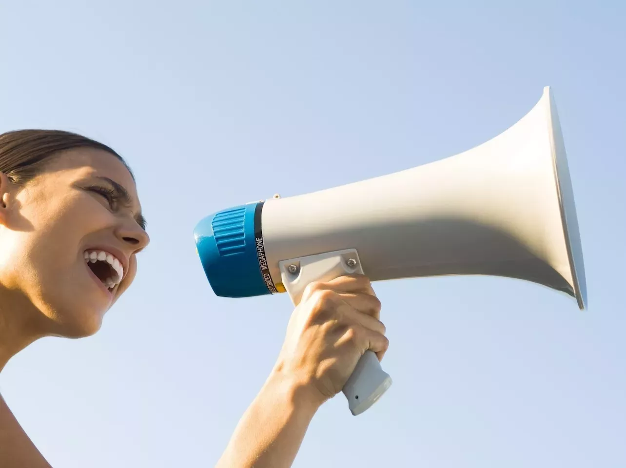 person speaking through megaphone