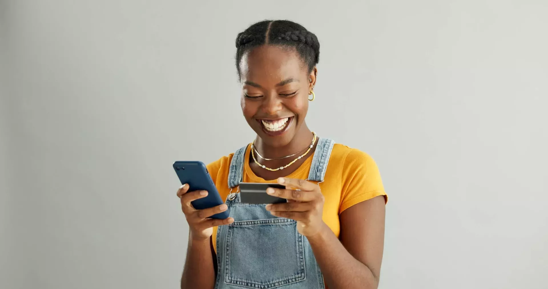 Young woman with phone and credit card Young woman with phone and credit card