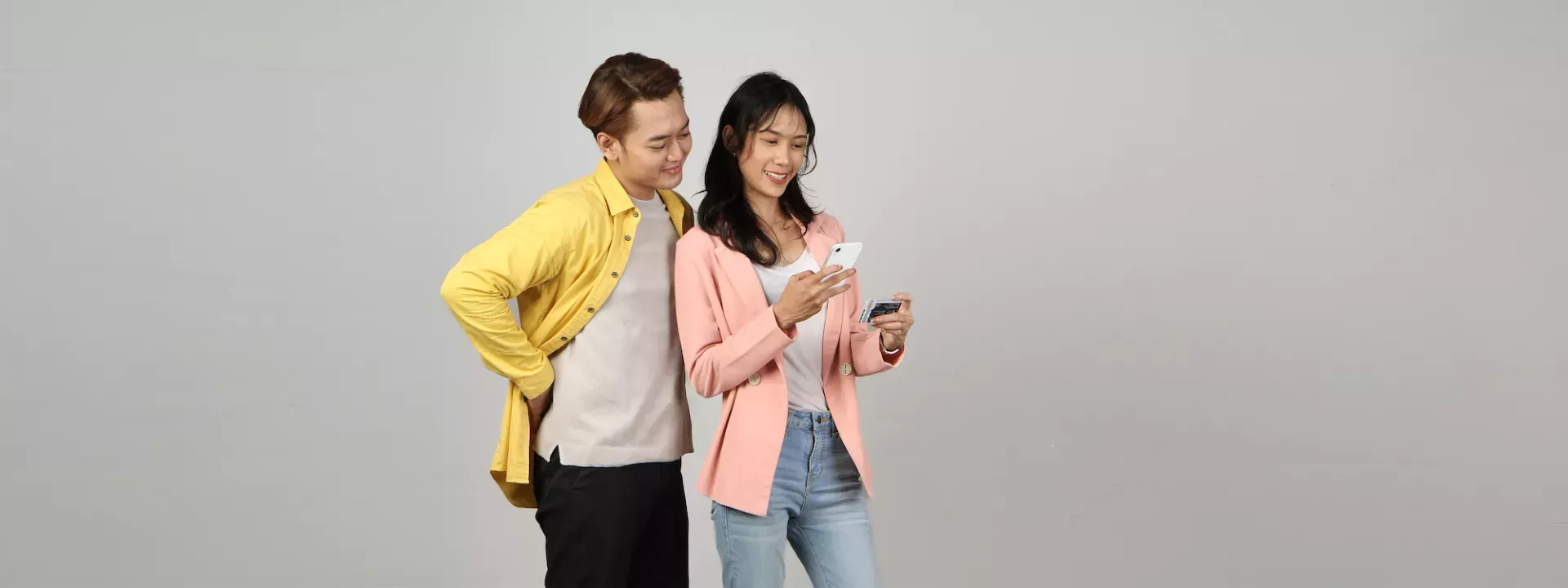 Man and woman with card and phone