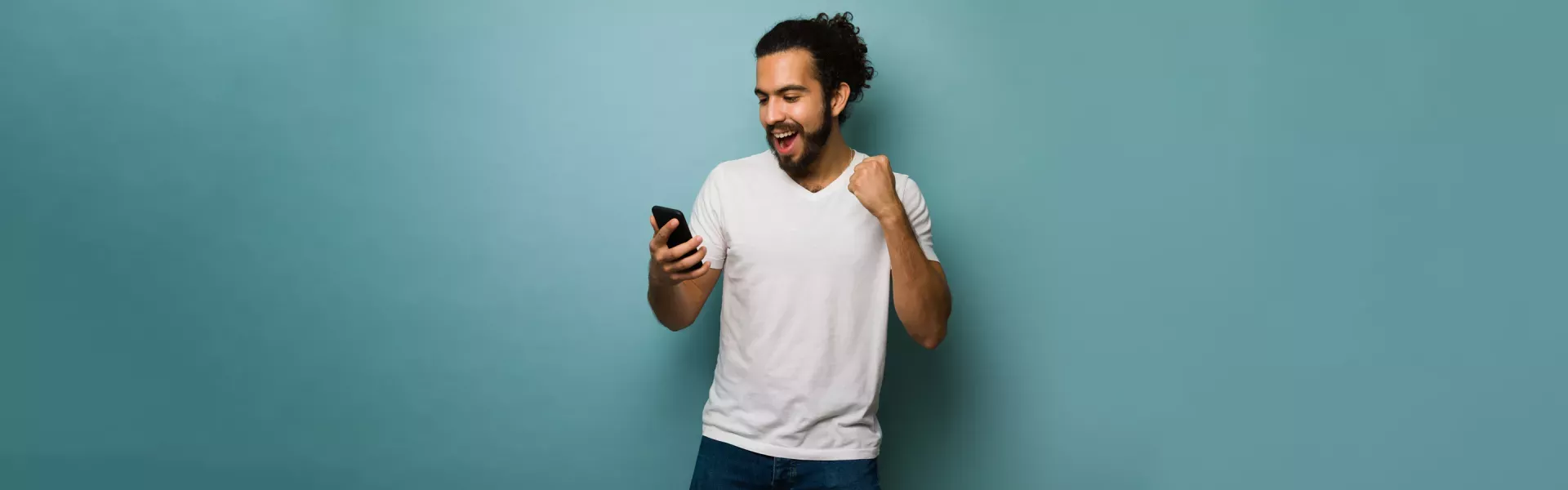 man holding cell phone smiling